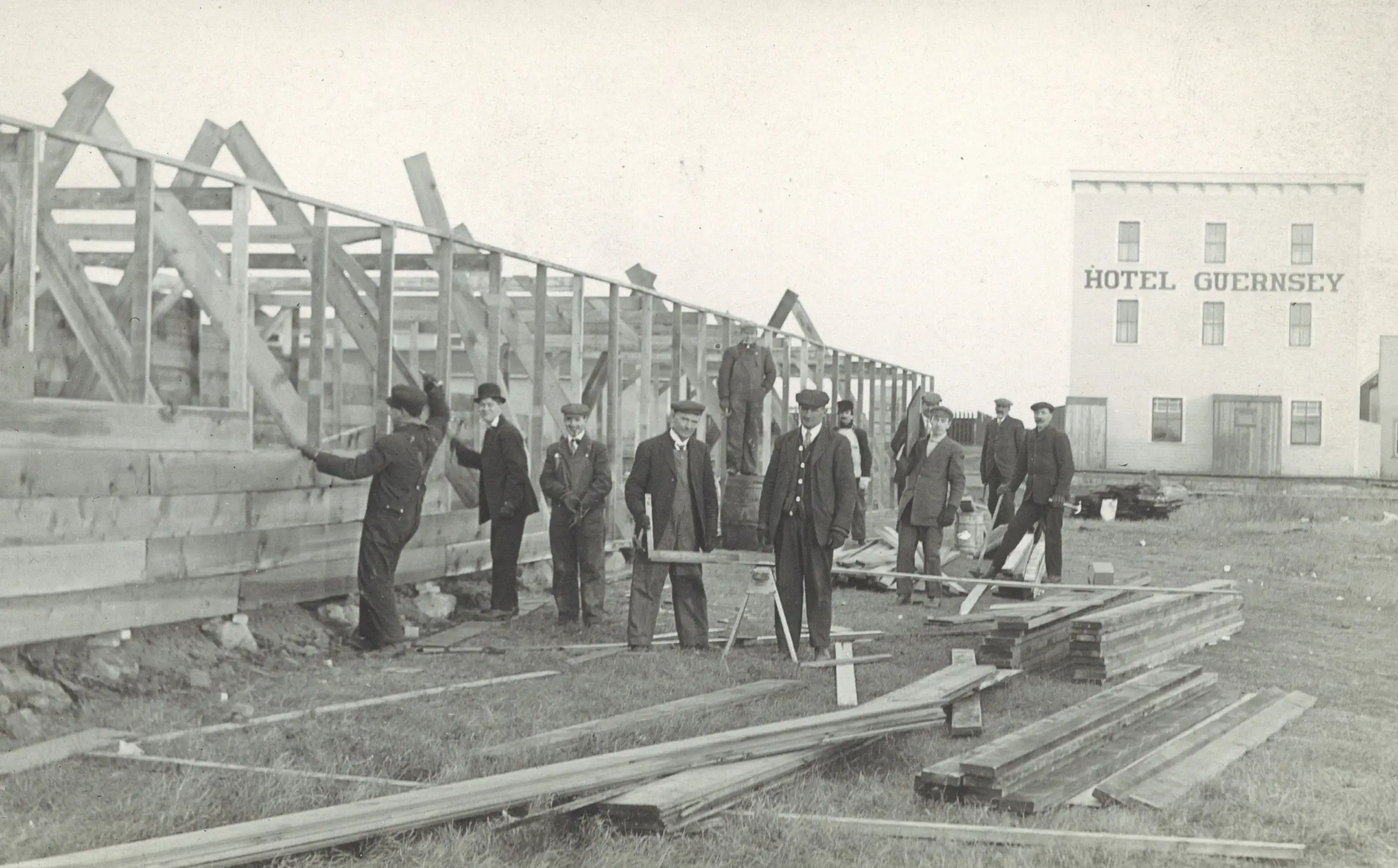 Men building a frame structure near Hotel Guernsey